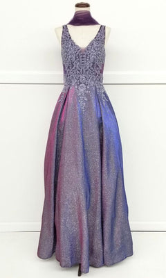 The Chicas DM4017 Lace-Bodice Long Glitter Prom Dress features a sleeveless, floor-length embroidered lace bodice and a sparkling ombre skirt in purple, pink, and blue, shown on a dress form.