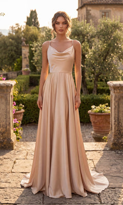 A woman wearing the Shoulder-Tie Long A-Line Prom Dress (Chicas DM4018) stands outdoors on a stone path, surrounded by greenery and potted plants.