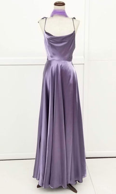 The Chicas DM4018 Shoulder-Tie Long A-Line Prom Dress, featuring a floor-length lavender satin design with a cowl neckline and matching scarf, is elegantly displayed on a dress form.