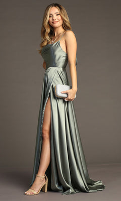A woman in the Chicas DM4018 Shoulder-Tie Long A-Line Prom Dress stands against a plain background, holding a silver clutch and wearing high-heeled sandals.