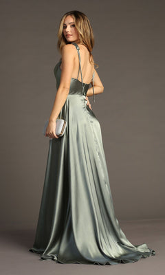 Woman in the Chicas DM4018 Shoulder-Tie Long A-Line Prom Dress, featuring a silky light green fabric and open back, holds a silver clutch against a plain gray background.