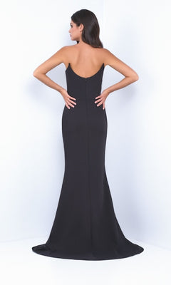 A woman faces away from the camera in the Strapless Classic Black Prom Dress: Daris by Velvi, featuring a fitted silhouette and strapless design against a plain white background.