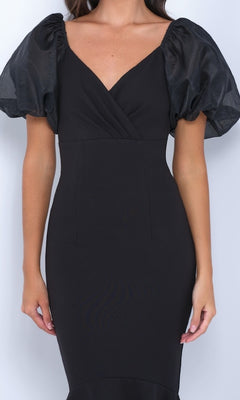 Model wearing the Velvi Short Sleeve Midi Semi-Formal Dress Diana in black, featuring a fitted silhouette, V-neckline, and short puffed sheer sleeves, shown from shoulders to knees against a plain background.
