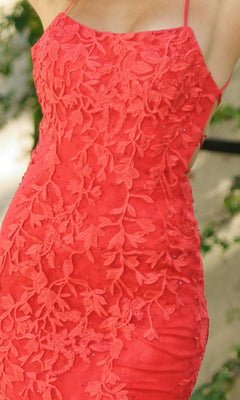 Model wearing the Beaded Lace Long Prom Dress Dutchess, a sleeveless red gown with floral lace details and thin straps, shown from shoulders to mid-thigh.