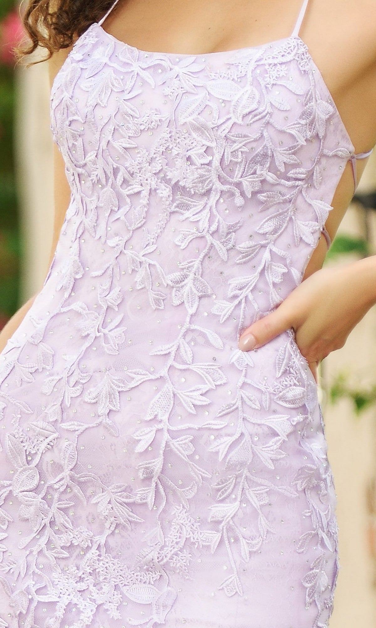 Someone wearing the Beaded Lace Long Prom Dress Dutchess, a fitted sleeveless lilac formal gown with intricate floral lace embroidery, shown from the shoulders to mid-thigh.