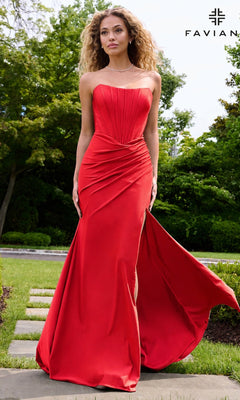 A woman wears a ruby Long Prom Dress: Faviana E11659, a strapless corset dress with a floor-length silhouette and a high side slit.
