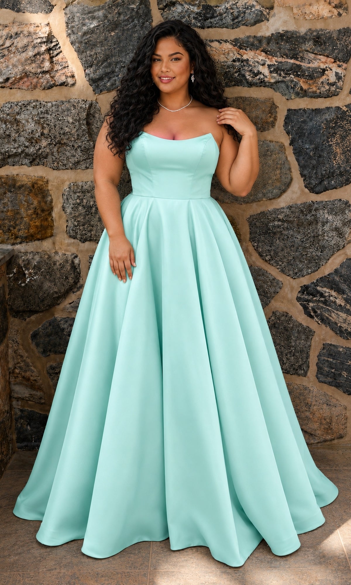 A plus-size person wears a Long Plus-Size Prom Dress: Faviana E11670E, a strapless, floor-length, sea glass green mikado A-line gown.
