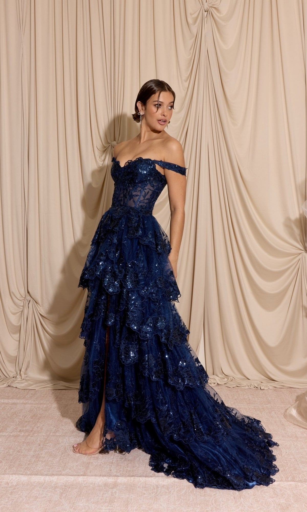 Off-Shoulder Long Ruffle Prom Dress: Eureka EK102 in navy blue, featuring an off-the-shoulder neckline, tiered ruffles, sequined floral detailing, and a high leg slit.