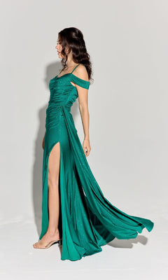 Woman in the Eureka EK107 Long Ruched Jersey Prom Dress with off-the-shoulder neckline and thigh-high slit, standing sideways against a plain light background.