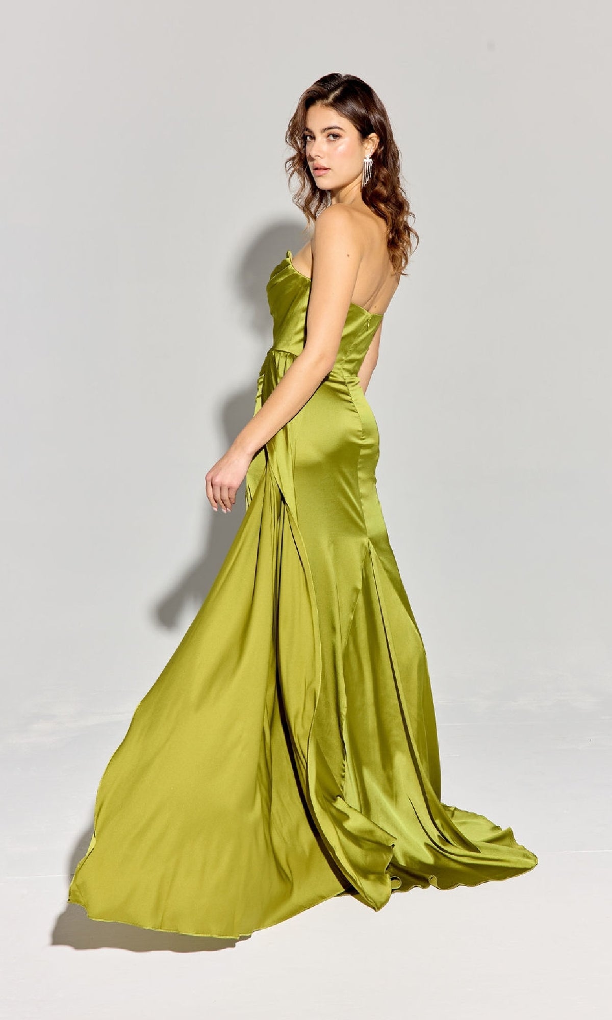 A woman models the Strapless Long Satin Prom Dress: Eureka EK118, standing against a plain light gray background and looking over her shoulder.