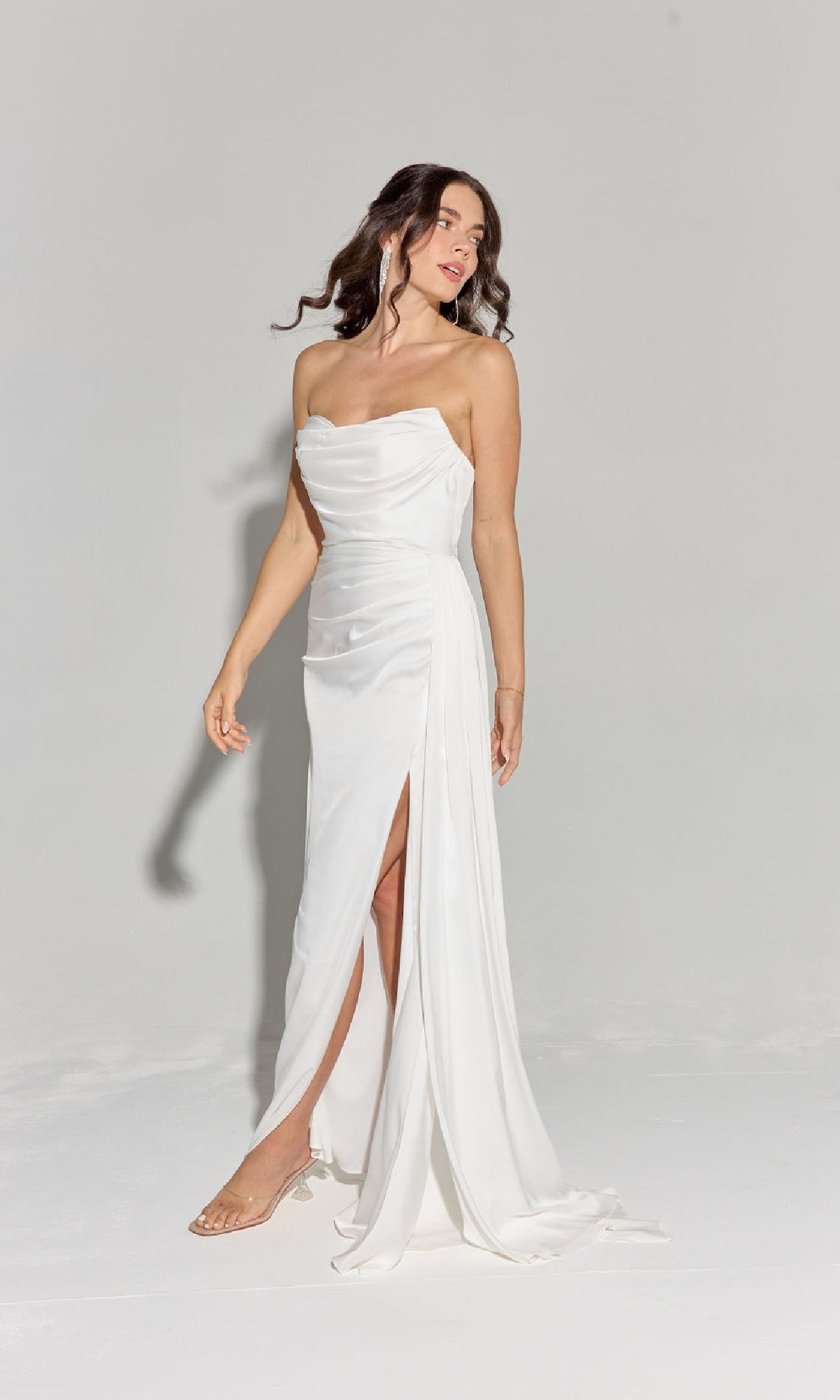 A woman models the Strapless Long Satin Prom Dress: Eureka EK118, featuring a thigh-high slit, against a plain light background.