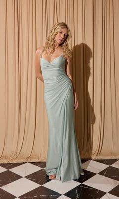 A woman with blonde curly hair wears the Classic Long Satin Prom Dress: Eureka EK136 in mint, floor-length and sleeveless, standing on a black and white tiled floor with beige draped curtains behind her.