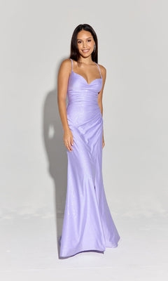 A woman stands against a plain background wearing the Classic Long Satin Prom Dress: Eureka EK136, a floor-length, light purple evening gown with thin straps, a fitted bodice, and an elegant formal silhouette.