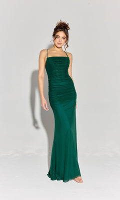A woman poses against a plain backdrop wearing the Eureka EK177 Strappy-Back Slinky Long Prom Dress in dark green, featuring spaghetti straps and a fitted, floor-length silhouette.
