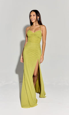 A woman smiles and faces slightly right, wearing the Spaghetti-Strap Long Formal Dress: Eureka EK187—light green, sleeveless, with a ruched bodice and high side slit.