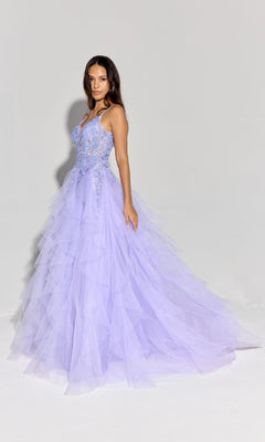 A woman in the Ruffled Long Glitter Prom Ball Gown: Eureka EK188, a light purple, floor-length tulle dress with floral embroidery, stands against a plain background, showcasing the elegance and sparkle of this glamorous evening gown.