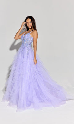 A woman poses in a studio, smiling with one hand near her hair, wearing the Eureka EK188 Ruffled Long Glitter Prom Ball Gown—light purple tulle with thin straps and floral details.