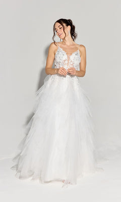 A woman in the Ruffled Long Glitter Prom Ball Gown, Eureka EK188, featuring a white layered tulle skirt and lace floral bodice, stands against a plain light background, looking left and smiling.