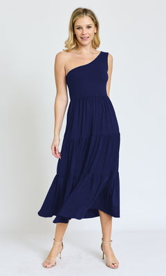 A woman poses against a plain background wearing the One-Shoulder Casual Everyday Midi Dress in navy blue with tiered layers, paired with nude heels.