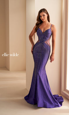 A woman stands by a window wearing the Sheer-Side Ellie Wilde Designer Prom Dress EW35001, a fitted, floor-length purple beaded mermaid gown with sheer side panels. “Ellie Wilde” is displayed on the left side.