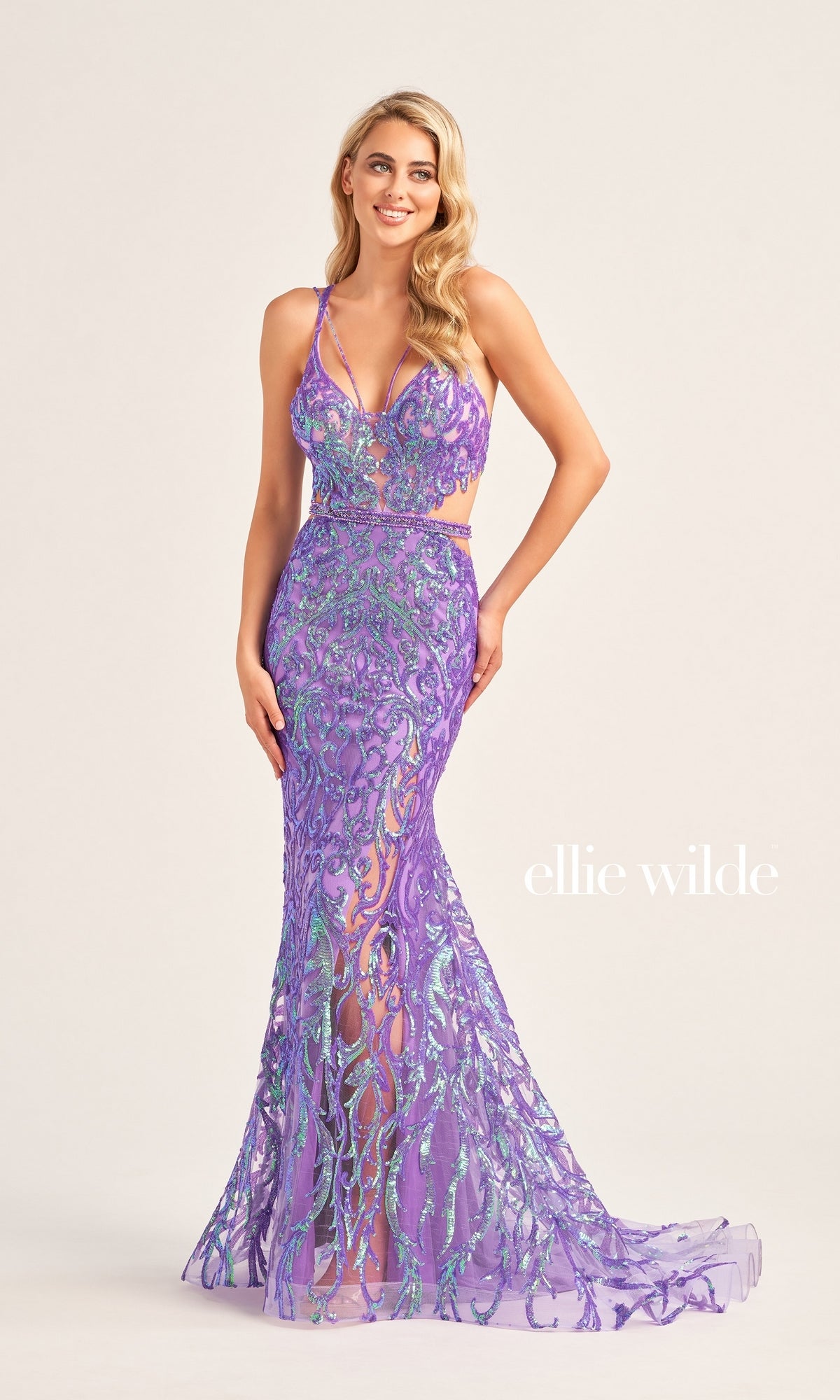 A woman wears the Ellie Wilde Cut-Out Long Sequin Prom Dress EW35007, a fitted, floor-length purple and blue dress with thin straps, posing against a plain background. 