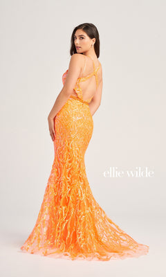 A woman poses in the Ellie Wilde Cut-Out Long Sequin Prom Dress EW35007, a fitted floor-length gown with orange and gold sequins, thin straps, cut-out sides, and an open back. The text "Ellie Wilde" appears on the image.