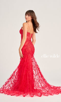 Woman in a fitted, floor-length red beaded-tulle dress with thin straps and floral patterns, facing slightly away. The Ellie Wilde EW35010 prom dress combines elegance with eye-catching beaded embroidery. "ellie wilde" appears on the right side.