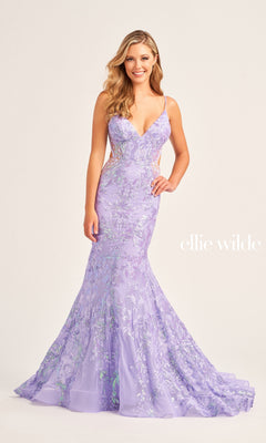 A woman wears the Ellie Wilde Long Tulle Designer Prom Dress EW35011—a fitted lavender sequin floral gown with thin straps and a mermaid silhouette—standing against a plain light background. "ellie wilde" appears on the right.