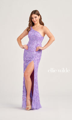 A woman wearing the Ellie Wilde One-Shoulder Beaded Prom Dress EW35021 in lavender, featuring sequins and a thigh-high slit, stands against a plain background. "ellie wilde" appears in the lower right corner.