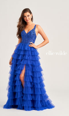 A woman wears the Tiered Ellie Wilde EW35059 Designer Ball Gown, featuring a sequin corset bodice and ruffled tiered skirt, posing against a light background with "Ellie Wilde" written beside her.