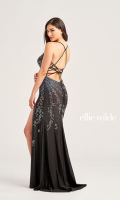 A woman poses sideways in the Ellie Wilde Sleek Long Glitter Prom Dress EW35061, featuring silver embellishments, a lace-up back, and a high slit. "Ellie Wilde" appears on the right to showcase this elegant formal gown.