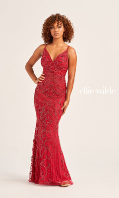 A woman wears the Long Beaded Ellie Wilde V-Neck Prom Dress EW35065, featuring a fitted, sleeveless design with intricate beadwork, standing against a plain light background. "Ellie Wilde" is displayed on the right.