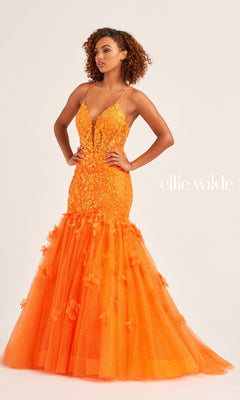 A woman stands hands-on-hips against a plain background, wearing the Ellie Wilde Designer Mermaid Prom Dress EW35080—an orange, floor-length fitted gown with floral appliqué and thin straps. "Ellie Wilde" appears at right.