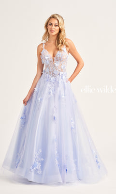 A woman wearing an Ellie Wilde Bright Pink Prom Ball Gown EW35122 with a sheer, corset-style bodice and spaghetti straps stands against a plain background.