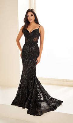 A woman wearing the Sequin-Print Mermaid Prom Dress Ellie Wilde EW36003 with a fitted silhouette stands indoors by a window.