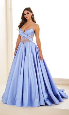 A woman wearing the Sheer-Corset Prom Ball Gown: Ellie Wilde EW36073—a light blue, floor-length dress with pockets, a fitted cut-out bodice, and thin straps—stands indoors against a neutral background.