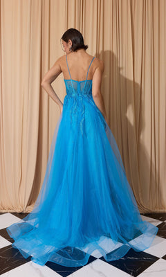 A woman faces away from the camera, wearing the Overskirt Long Sequin Prom Dress: Eureka EK112—a bright blue, floor-length tulle gown with a corset-style, sequin bodice—standing before beige curtains on a black-and-white floor.