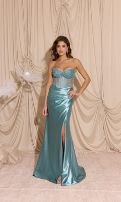 A woman stands before beige curtains wearing the Eureka EK183 Strapless Tight Satin Prom Dress in blue-green, featuring a beaded sheer corset bodice and thigh-high slit—ideal for formal events.