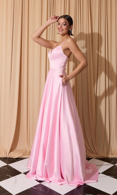 A woman poses on a black-and-white floor in front of beige curtains, wearing the Eureka EK190 long prom dress in light pink satin with thin straps and an open back.