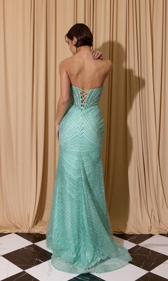 A person wearing the Long Prom Dress: Eureka EK195, featuring a strapless light teal corset bodice and lace-up back, stands on a black-and-white checkered floor before beige curtains.