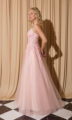 A woman in the Eureka EK197 long prom dress, featuring sleeveless light pink lace appliques and floral embroidery, stands sideways on a checkered floor against beige curtains.