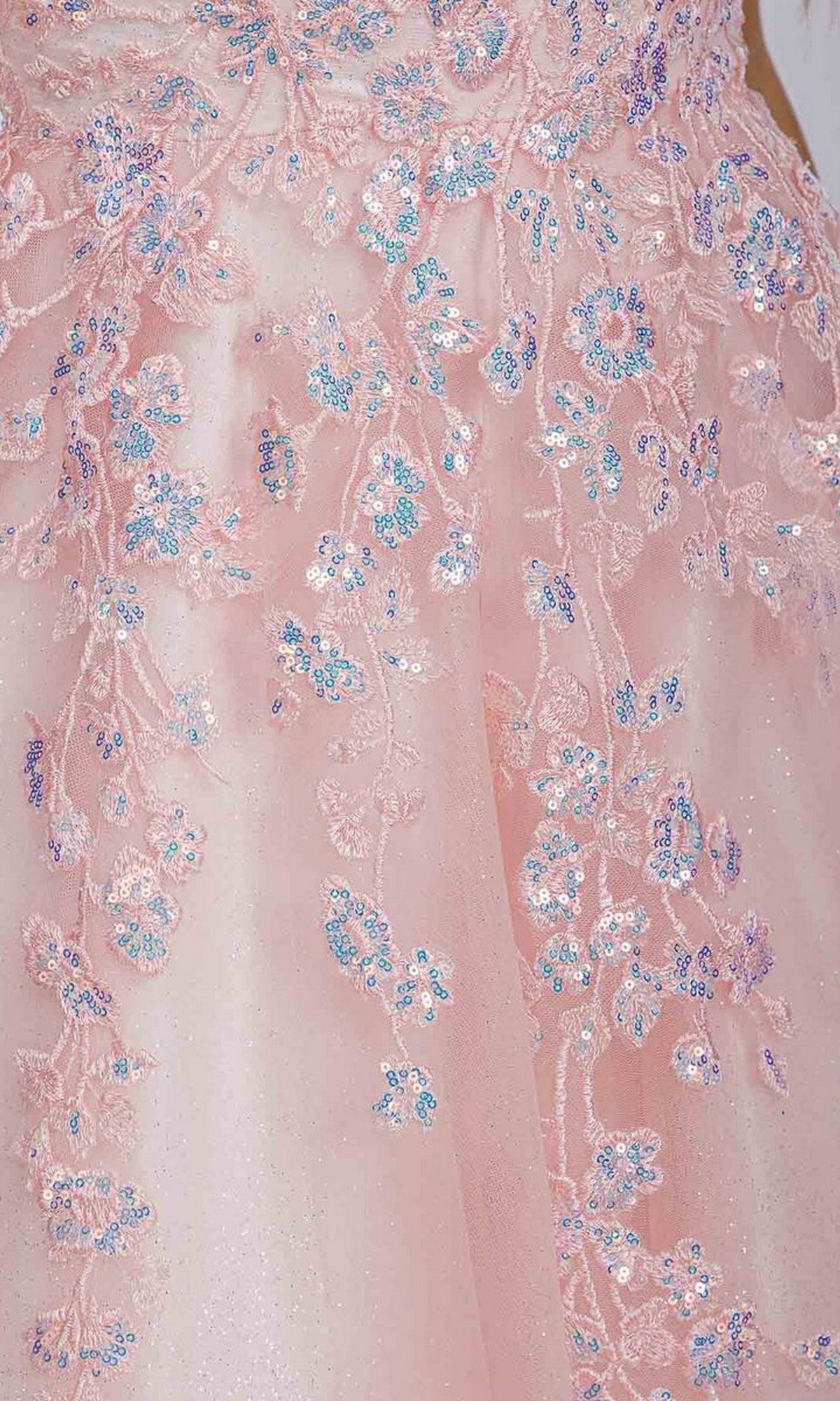 Close-up of pink fabric with intricate floral embroidery and sequins, accented in blue and purple—ideal for creating a shimmering Long Prom Dress: Eureka EK197 or for lace appliques on the same style.