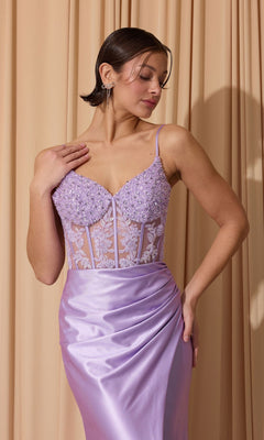 A woman stands in front of beige curtains wearing the Eureka EK203 long prom dress—a lilac, sleeveless gown featuring a beaded sheer corset bodice and a sheath skirt.