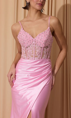 A person wearing the Eureka EK203 Long Prom Dress in light pink satin with a beaded, sheer corset bodice and sheath skirt stands in front of beige curtains.