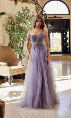A woman stands indoors in front of a staircase and large windows, wearing the Asymmetrical Glitter Prom Dress: Nox Anabel F1567 in English Violet, featuring a beaded bodice and tulle skirt.