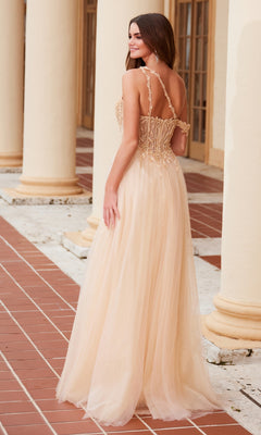 A woman in the Nox Anabel F1567 Asymmetrical Glitter Prom Dress, featuring a light beige, floor-length skirt and sheer straps, stands on a tiled walkway with her back to the camera.