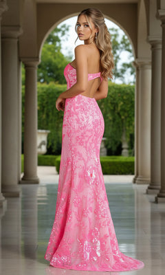 A woman stands sideways in an archway, greenery framing her neon sequin gown—a glamorous look in the PromGirl One-Shoulder Neon Sequin Long Prom Dress, perfect for making an unforgettable entrance.