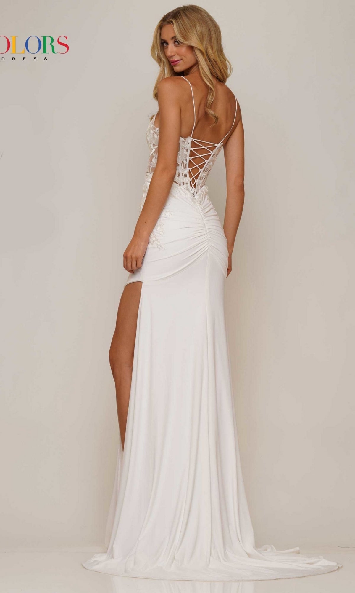 Model in the Lace-Up Open-Back Slinky Long Prom Dress G1086 features a white dress with thin straps, ruched detailing, high side slit, and lace-up open back, standing against a plain background.