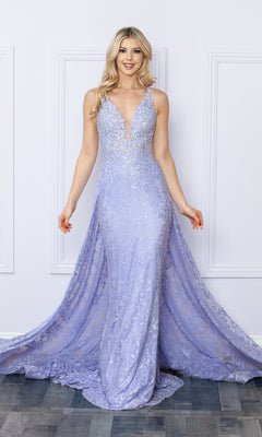 A woman stands indoors wearing the Open-Back Long Lace Prom Dress with Train G1353—a floor-length, sleeveless lavender gown with lace detailing and a deep V-neckline.