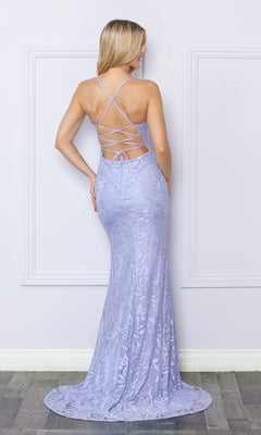 A woman wearing the Open-Back Long Lace Prom Dress with Train G1353 stands facing a white wall; the floor-length lavender gown features floral lace, a fitted mermaid silhouette, and a crisscross open back.